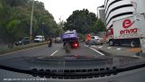 A crane loses its wheel in the middle of the road