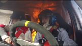A rally car catches fire