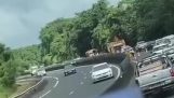 Motorist reverses on a highway to see an accident