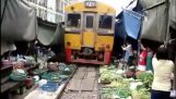 Bangkok train passes through the public market