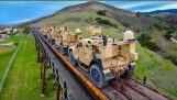 A drone flying behind a military train