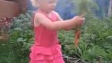 Little Russian girl harvesting carrots and saying blyat