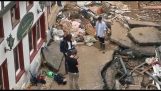 A journalist covers her face with mud before a television shoot