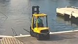 Forklift operator trying to pull a boat out of the water