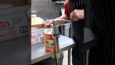 Professional chef opens a can of tomato sauce