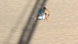 Crane operator trolls a woman on the beach who wants to sunbathe