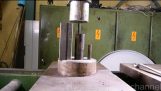 Crushing metal pipes with hydraulic press