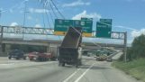Dump truck collides with a billboard on a highway