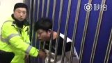 His head stuck in the railings of a cell