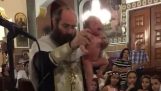 Опасно свештеник крштава бебу