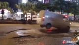 Vehicles pass over two huge potholes