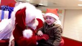 The Santa Claus speaks with a toddler in sign