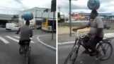 Cyclist transports gas bottle in the head
