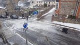 Pedestrians try to walk on an icy hill