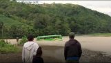 Scoala de autobuz care traversează un râu inundat