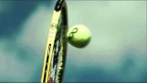 Squeezing a tennis ball on the racket