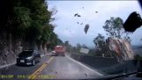 Driver saves for a bit of rock fall on the road