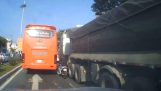 Um motociclista tenta passar entre um caminhão e um ônibus