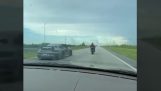 Motorcyclist against Prosche in a speed race