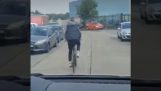 Cyclist blocks the road to a car