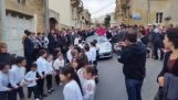 Children pulling a priest in a Porsche (Malta)